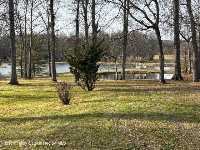 a swimming pool with trees in the background