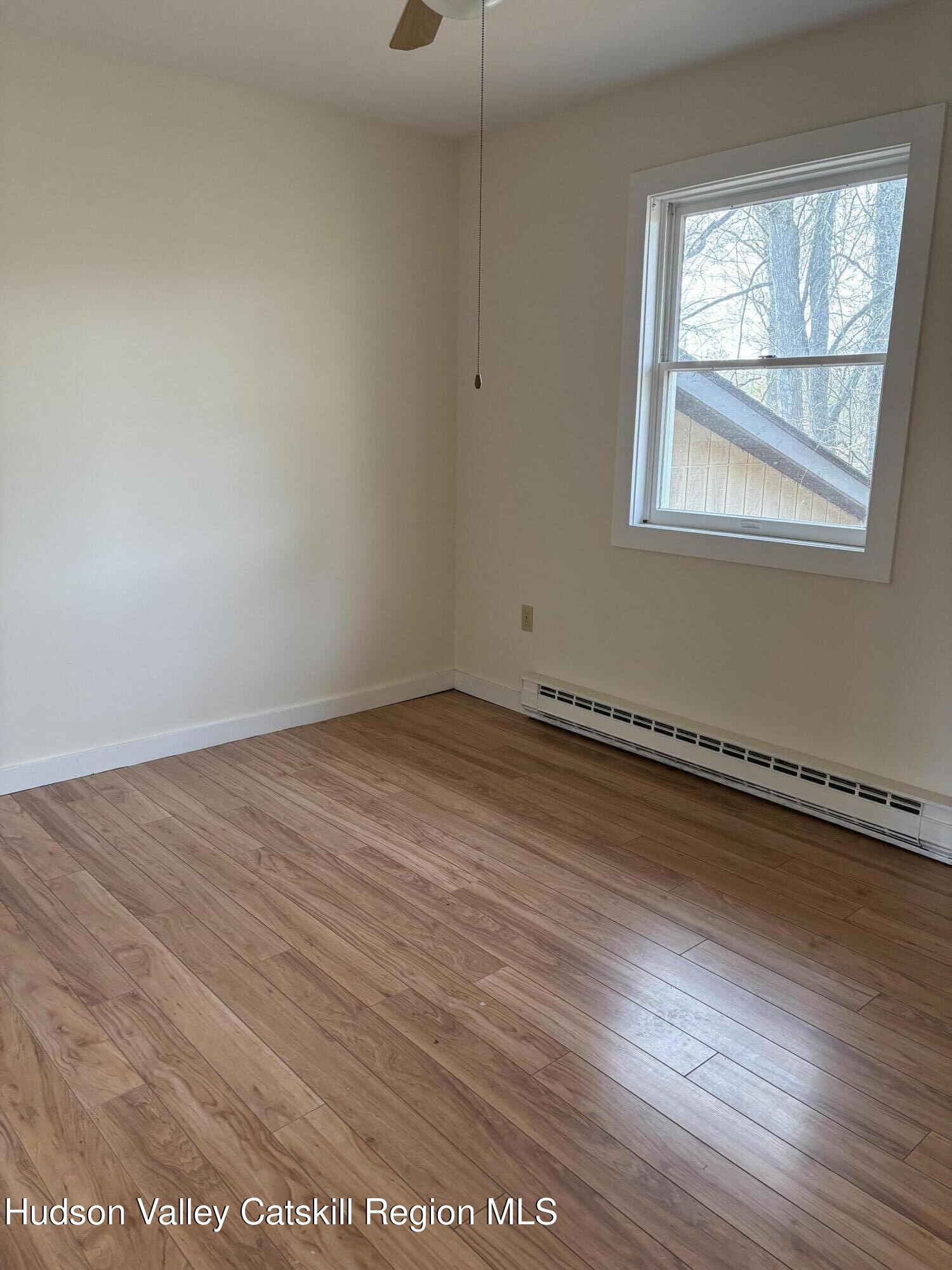 505 Highway 208, Unit 3 Gardiner, NY 12525 - Photo 10 of 11 an empty room with wooden floor and windows