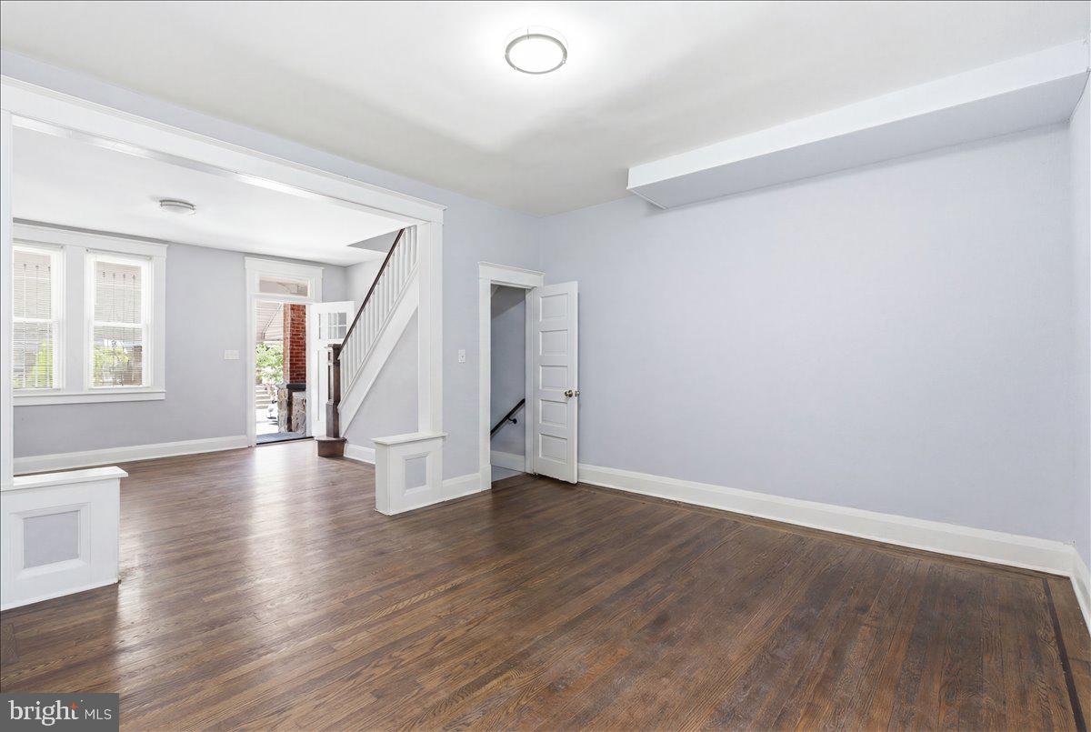 1231 North Potomac Street Baltimore, MD 21213 - Photo 7 of 25 an empty room with wooden floor and windows