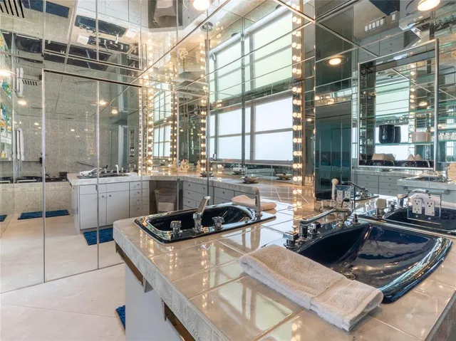 a kitchen with a stove a sink a refrigerator and cabinets