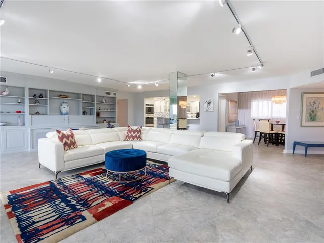 a living room with furniture and a dining table