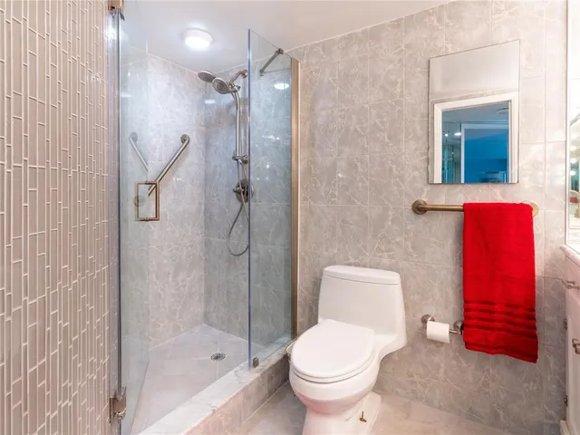 a bathroom with a toilet and a shower