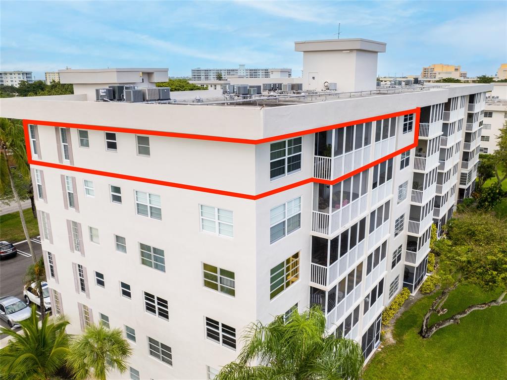2850 North Palm Aire Drive, Unit 601 Pompano Beach, FL 33069 - Photo 4 of 41 a tall building with a lot of windows