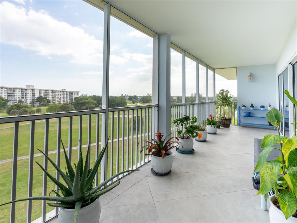 2850 North Palm Aire Drive, Unit 601 Pompano Beach, FL 33069 - Photo 7 of 41 a view of a chairs and table in patio with potted plants