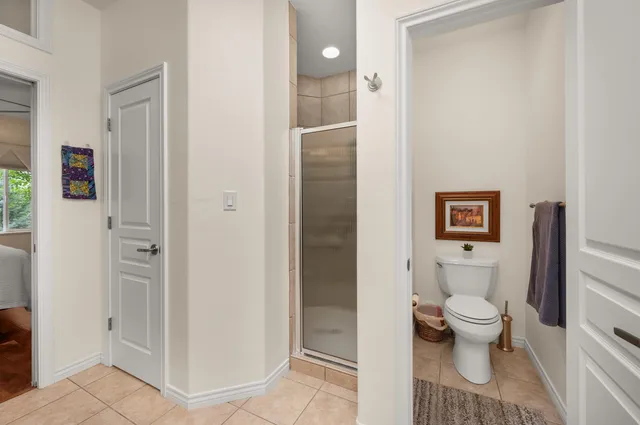 a bathroom with a toilet and a shower