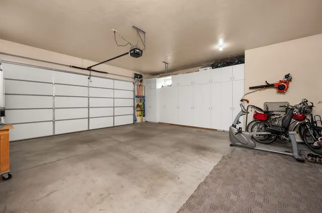 a view of a garage with rack and bicycle