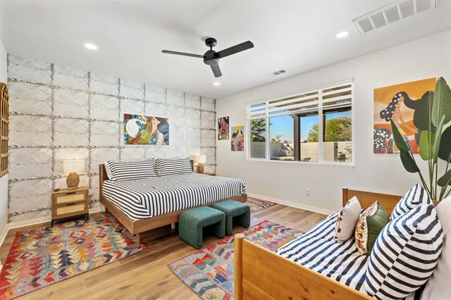 a spacious bathroom with a sink a large mirror and vanity