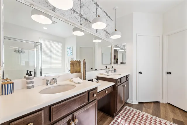 a view of a hallway with wooden floor and workspace