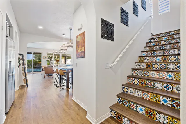 a room with furniture pool table and wooden floor