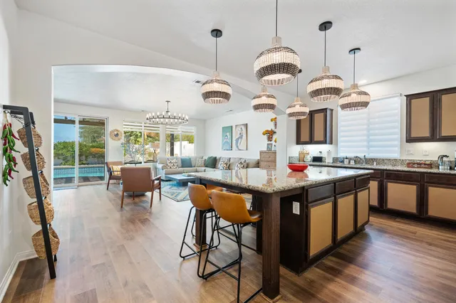 a kitchen with a granite countertop sink and natural light