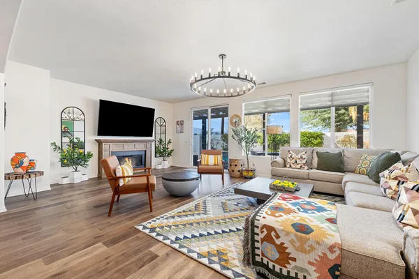 a living room with furniture potted plant and a large window