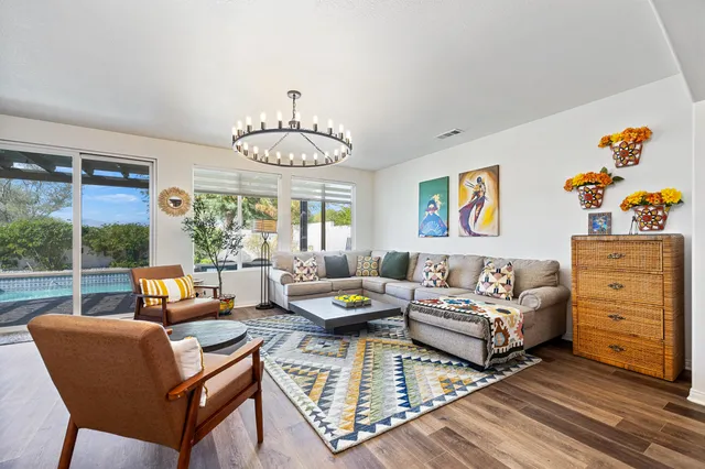 a view of a patio with table and chairs and wooden floor