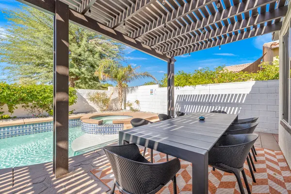 a view of a patio with couches table and chairs and potted plants