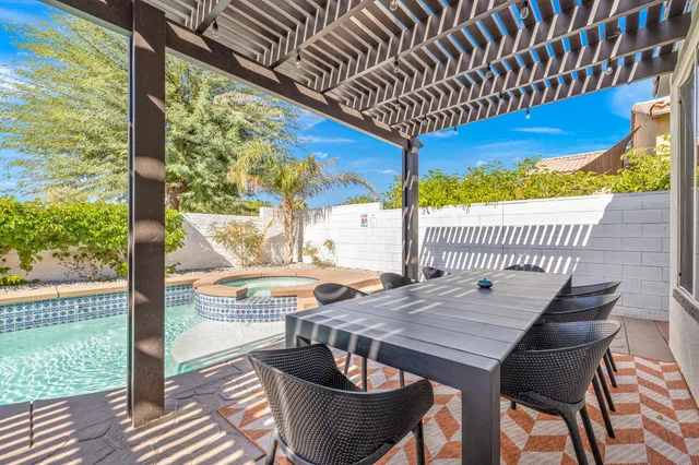a view of a patio with couches table and chairs and potted plants