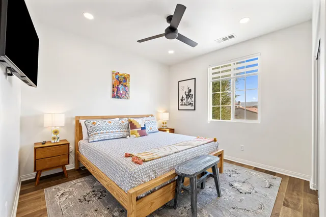 a bedroom with a bed and a flat screen tv