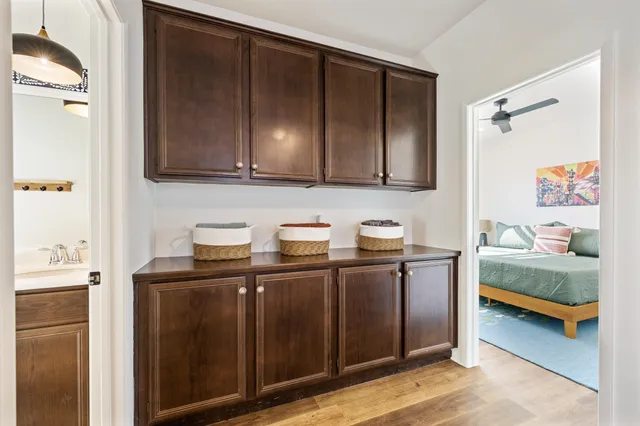 a bedroom with a bed and a painting on the wall