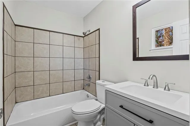 a bathroom with a toilet a sink and bathtub