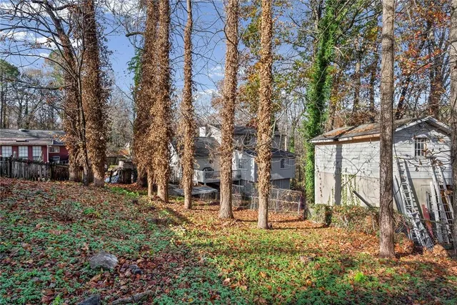 a backyard of a house with table and chairs