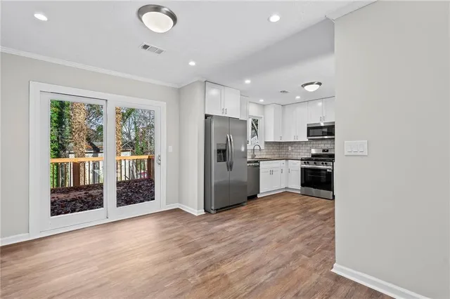 a kitchen with stainless steel appliances granite countertop a refrigerator and a sink