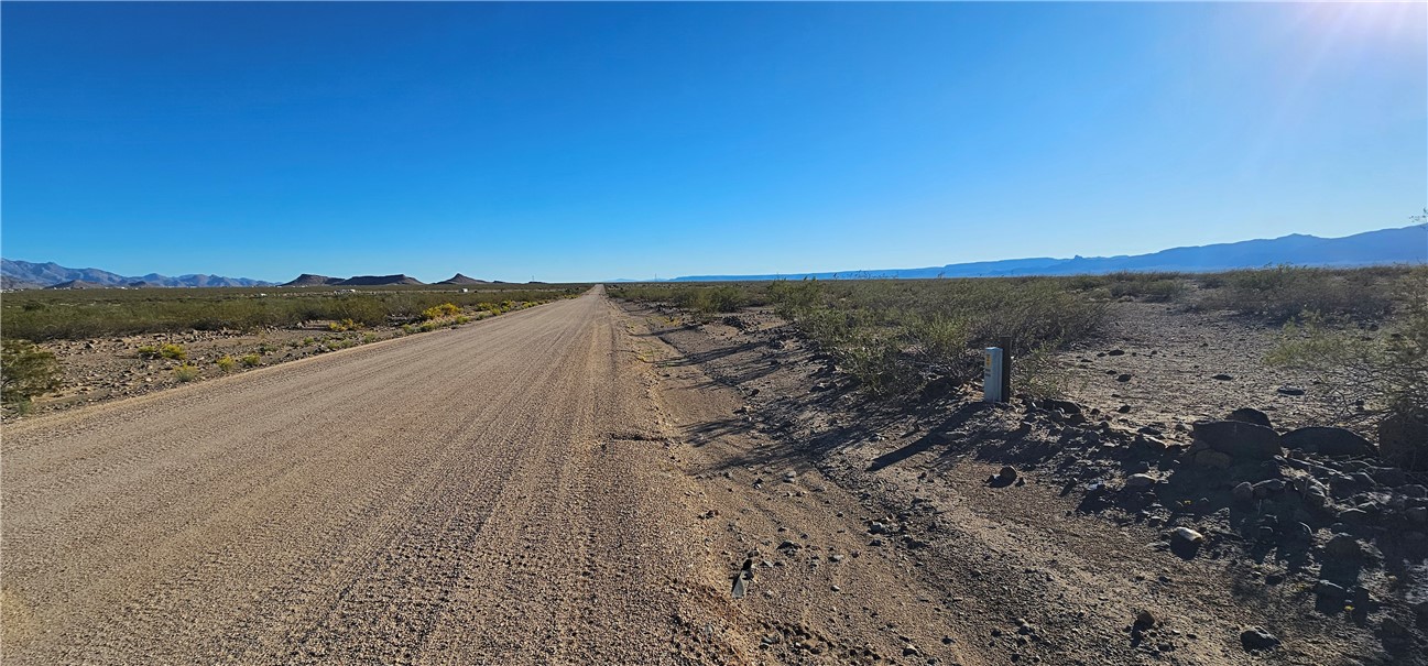 View of dirt / gravel road with a mountain view