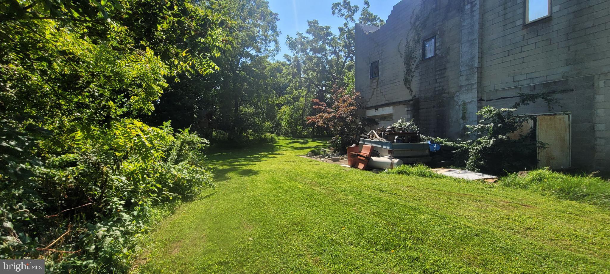 6677 Church Road Felton, PA 17322 - Photo 6 of 6 a view of a backyard with plants and a fountain