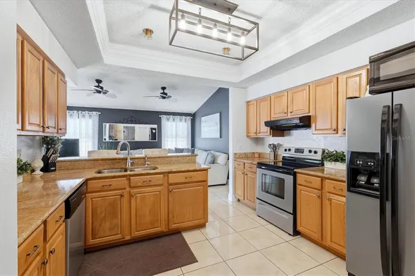 a kitchen with stainless steel appliances granite countertop a sink stove and refrigerator