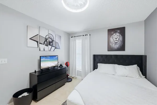 a bedroom with a bed and a television