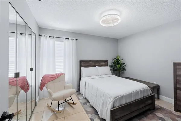 a bedroom with a bed and a chair