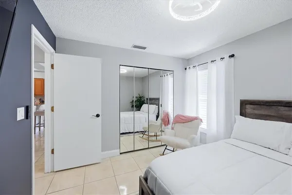 a bedroom with a bed and a mirror