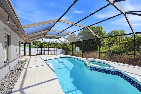 a view of a patio with a table chairs and a backyard