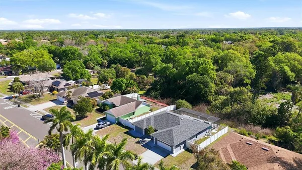 an aerial view of a house with yard swimming pool and outdoor seating