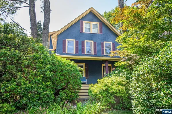 a view of a house with potted plants and more windows