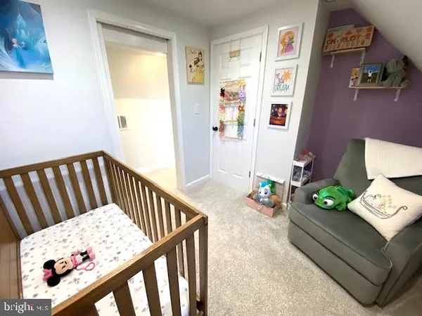 a bedroom with furniture and a book shelf