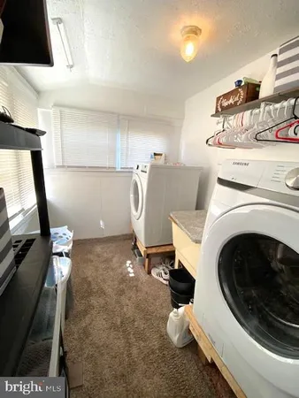 a utility room with sink dryer and washer