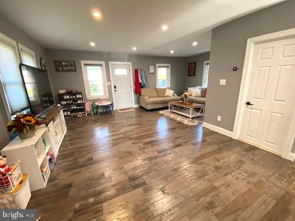 a living room with furniture a large window and gym equipment