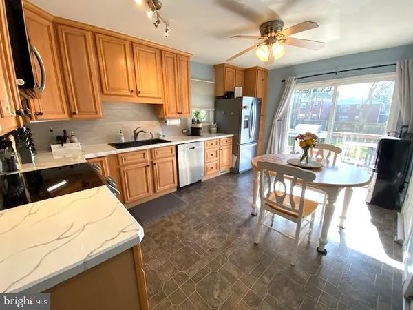 a kitchen with a stove a sink and a refrigerator
