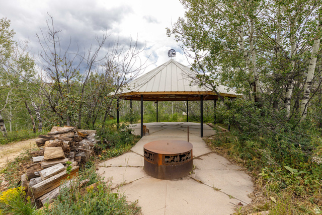 23 Scare Canyon, Unit 23 Logan, UT 84321 - Photo 22 of 33 Outdoor gazebo with a metal roof and open-air design, complemented by a central fire pit