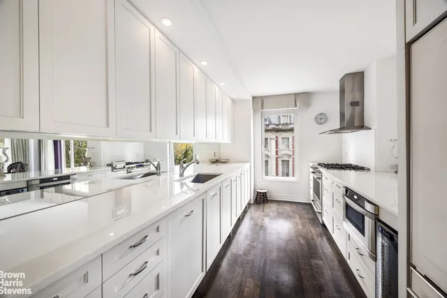 a kitchen with stainless steel appliances sink stove top oven and cabinets
