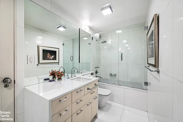 a bathroom with a sink double vanity and a shower