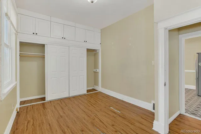 a view of empty room with wooden floor