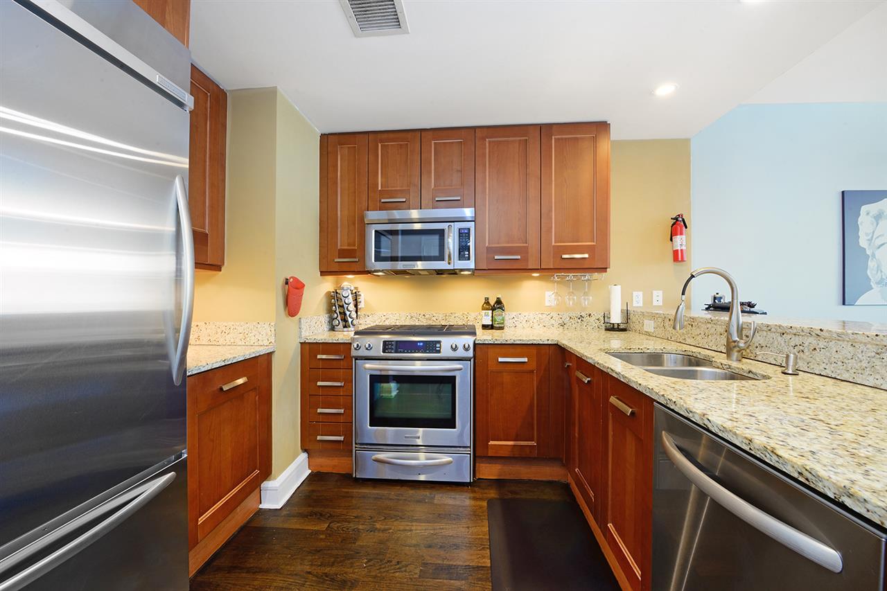 8100 River Road, Unit 310 North Bergen, NJ 07047 - Photo 1 of 1 a kitchen with stainless steel appliances granite countertop a sink stove and refrigerator