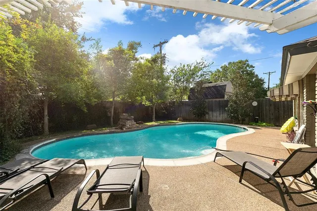 a view of a backyard with sitting area