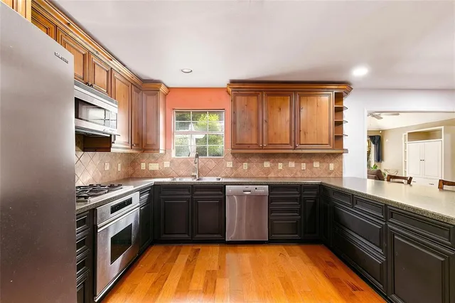 a kitchen with a sink stove top oven and cabinets