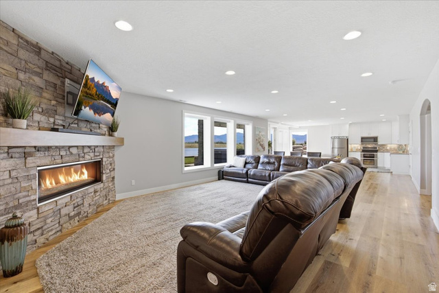 21 Pier Place Tooele, UT 84074 - Photo 51 of 112 Stone accent wall with a linear gas fireplace and wood mantel