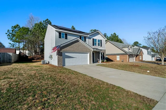 a front view of a house with a yard and garage
