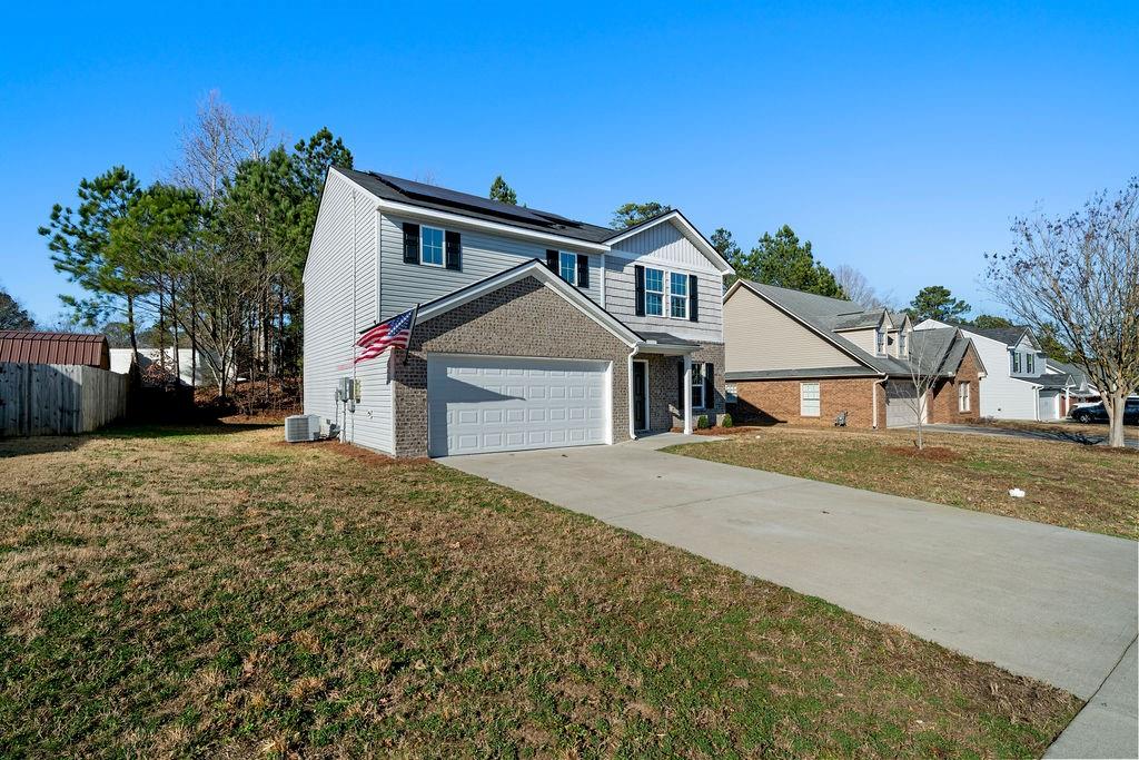 a front view of a house with a yard and garage