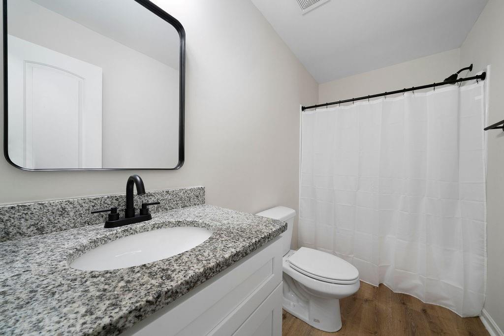 21 Walton Creek Drive Southwest Rome, GA 30165 - Photo 20 of 26 a bathroom with a granite countertop sink and a mirror