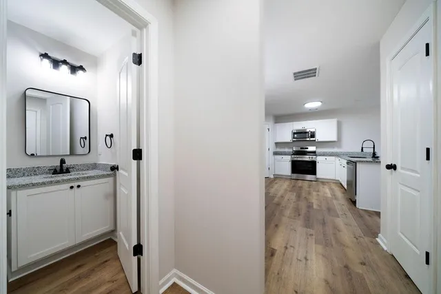 an empty room with windows and fan