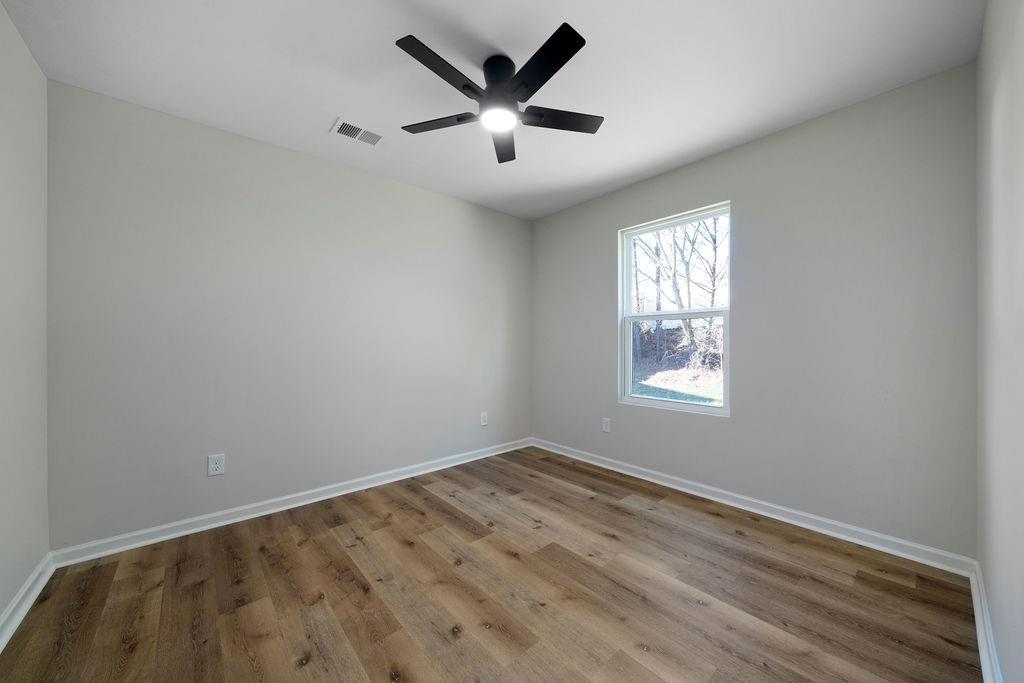21 Walton Creek Drive Southwest Rome, GA 30165 - Photo 9 of 26 an empty room with windows and fan