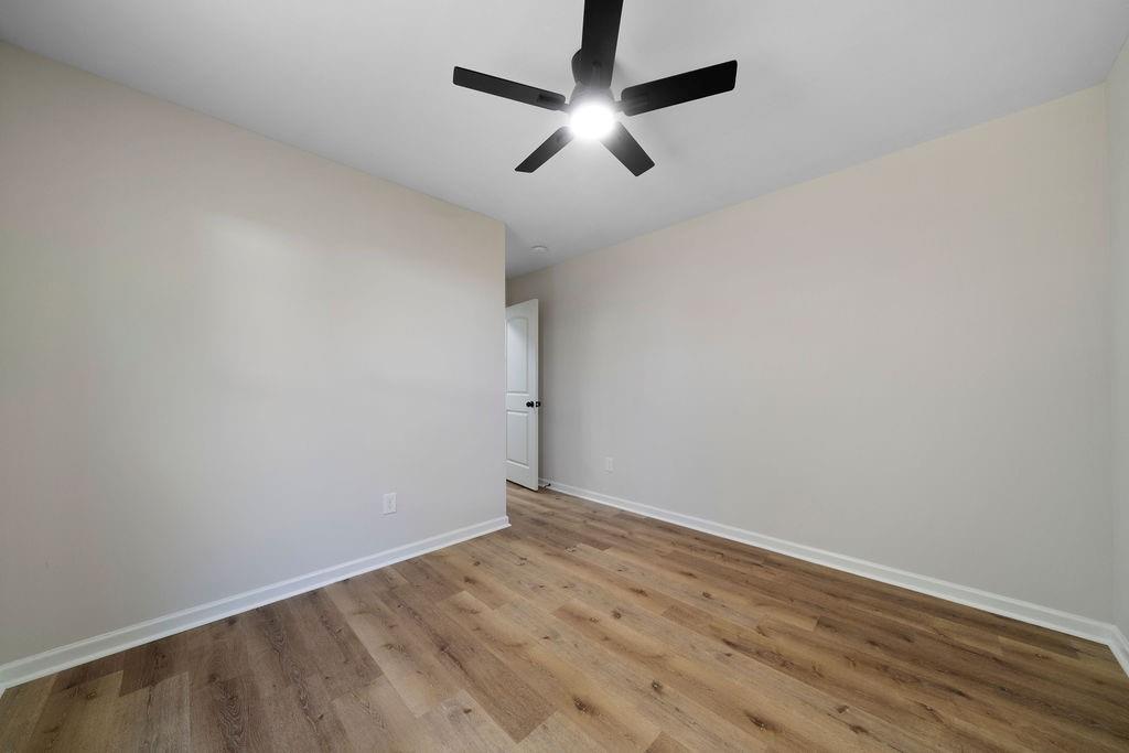 21 Walton Creek Drive Southwest Rome, GA 30165 - Photo 10 of 26 an empty room with wooden floor and ceiling fan